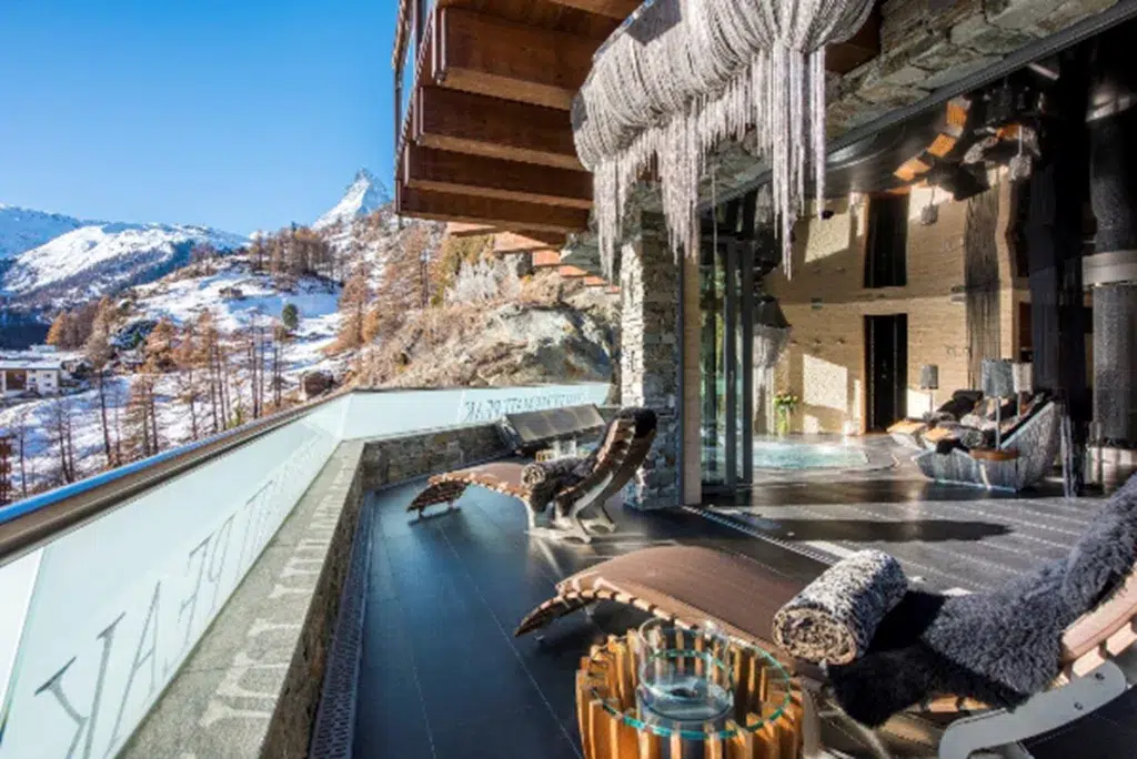 A patio with a large glass roof and a large icicles from it